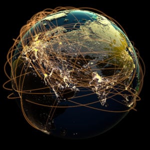 Global communications, rendered as many glowing lines encircling the planet